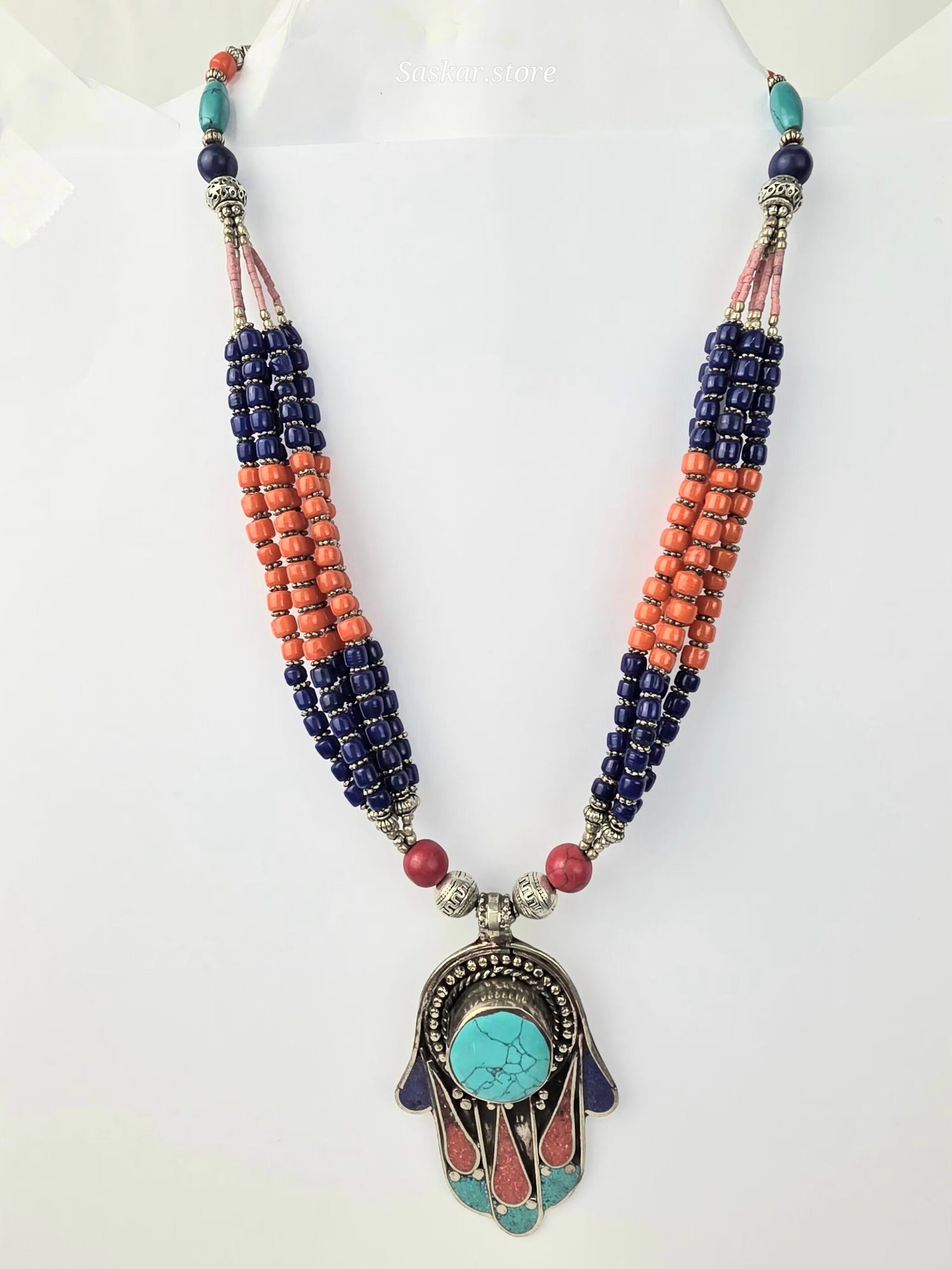 Multi-strand ethnic Tibetan necklace featuring lapis lazuli and coral beads with a Hamsa-style turquoise and coral inlay pendant